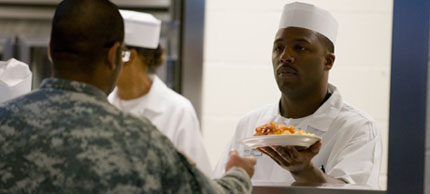 Photo of man serving food.